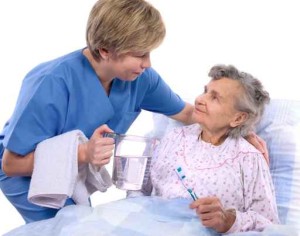 Nurse helps the senior woman in washing