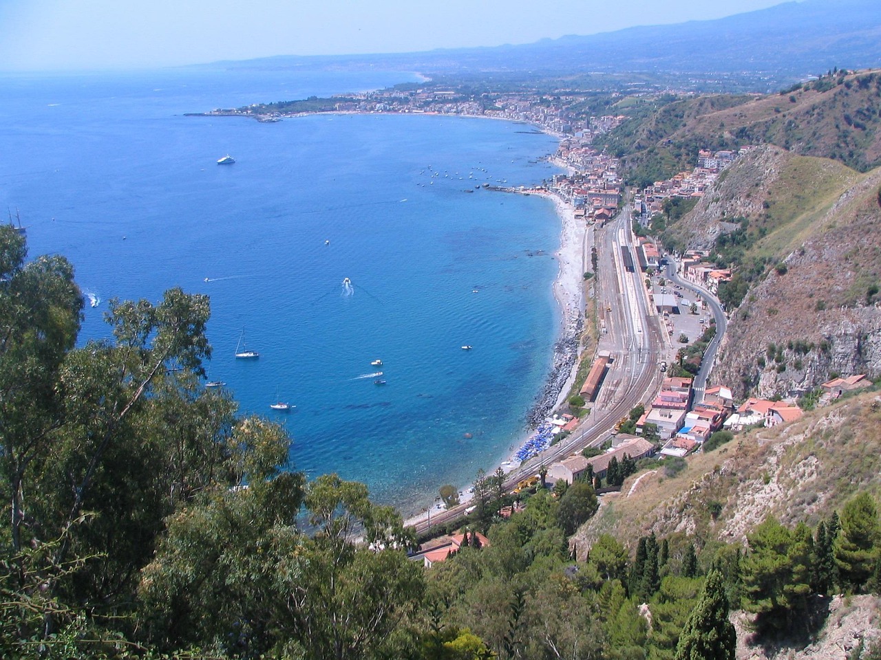 Panorama di Taormina con l'Etna sullo sfondo e le coste mozzafiato della Sicilia orientale.